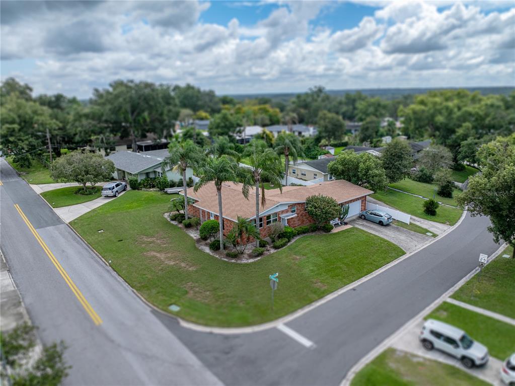 An aerial view of a single-story brick house on a corner lot with palm trees — 307 GLENDALE ST, LAKELAND, FL