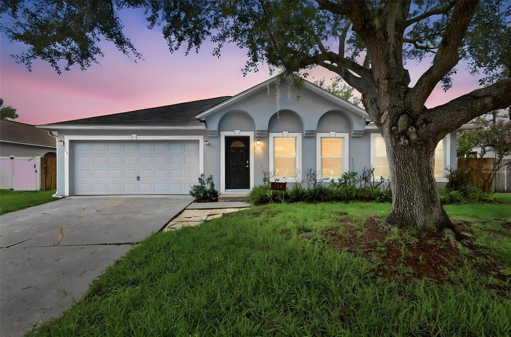 This is a floor plan of a single-story house featuring a garage, patio, and bedrooms — 134 CROWN COLONY WAY, SANFORD, FL