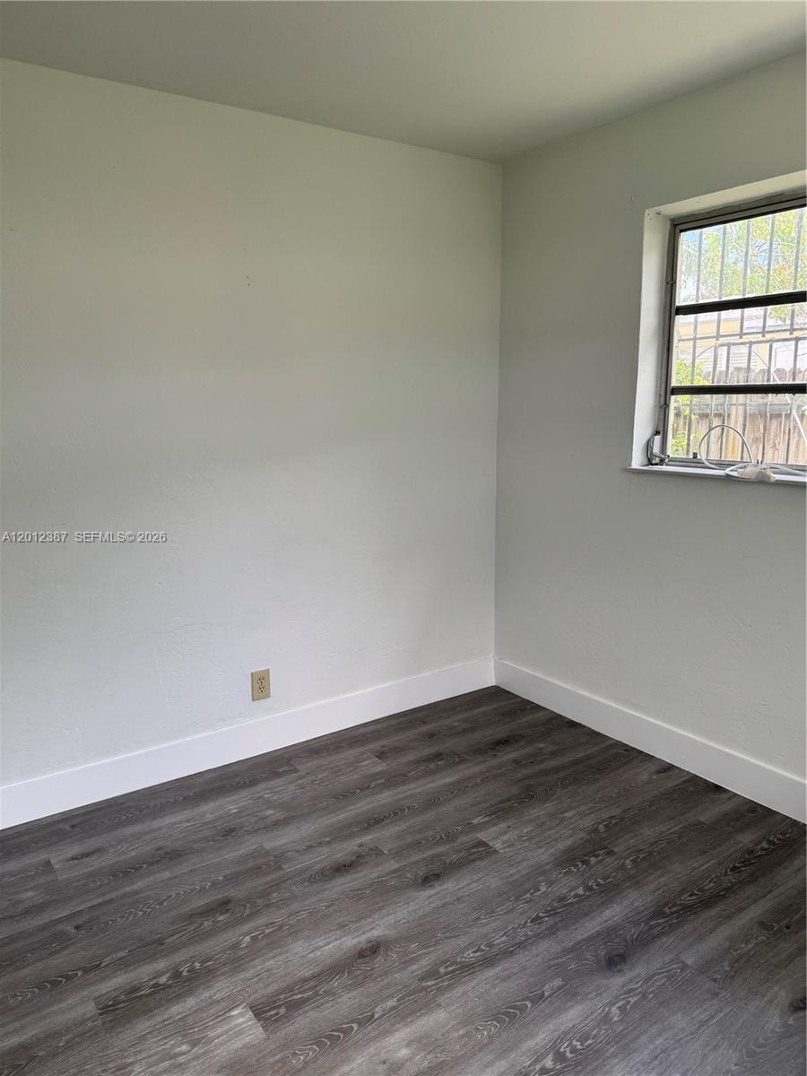 A bathroom features a vanity, toilet, and a walk-in shower with marble-look wall tiles — 2620 SW 53rd Ave, West Park FL 33023, WEST PARK, FL