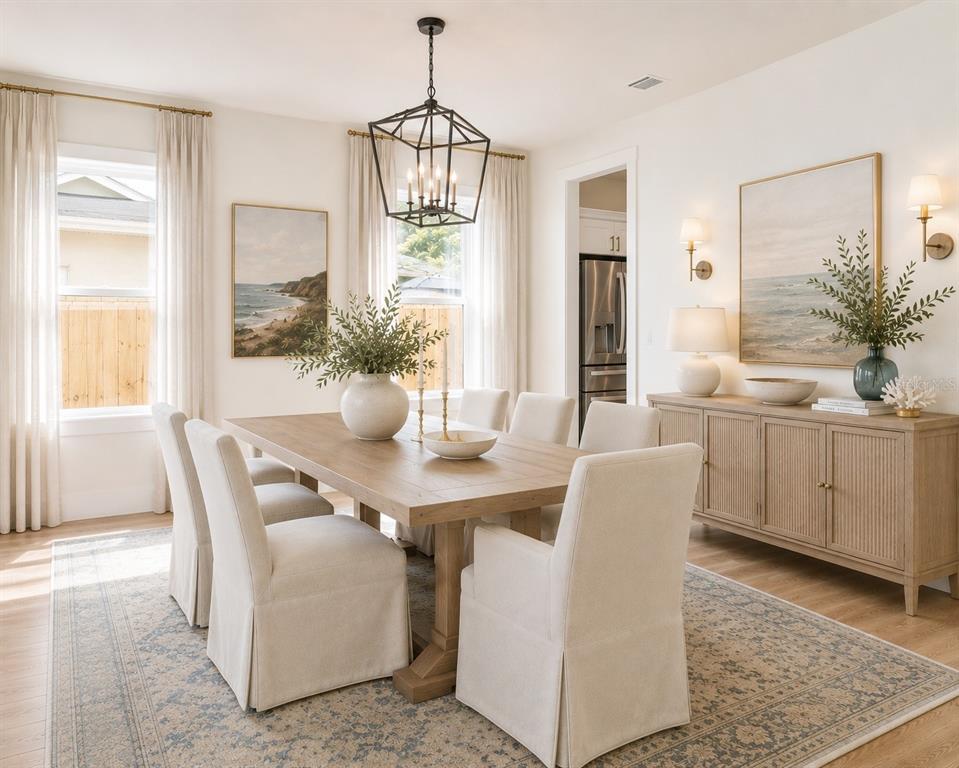 A dining room features a wooden table, upholstered chairs, a chandelier, and a sideboard — 3414 W CHEROKEE AVENUE, TAMPA, FL