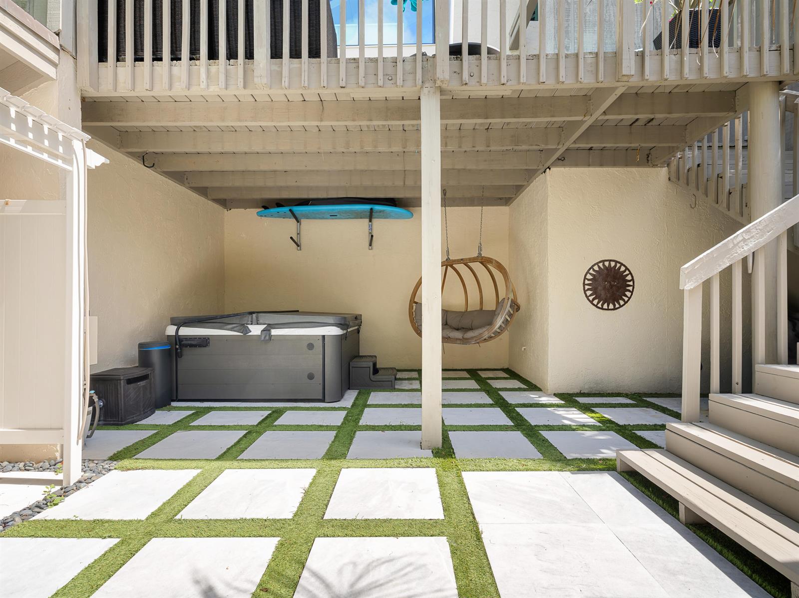 A covered patio features a hot tub, a hanging chair, and a surfboard on the wall — 1605 S Us Hwy 1 # 3h, Jupiter FL 33477, JUPITER, FL