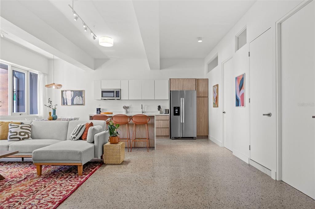 A modern open-concept living room and kitchen with white cabinetry and light wood accents — 606 CERRA ST, SAN JUAN, PR