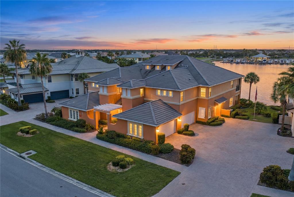 A screened-in patio features outdoor furniture, a dining set, and a view of a lake — 1139 RIVERSCAPE STREET UNIT 2, BRADENTON, FL