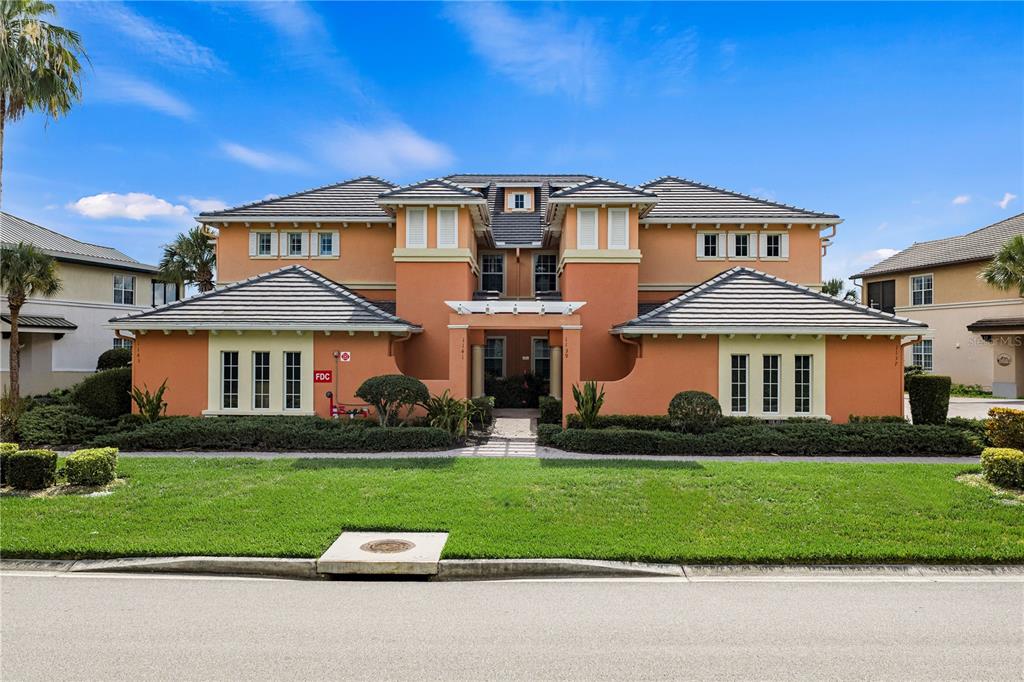 A two-story orange stucco building with a gray tile roof and a central entrance — 1139 RIVERSCAPE STREET UNIT 2, BRADENTON, FL