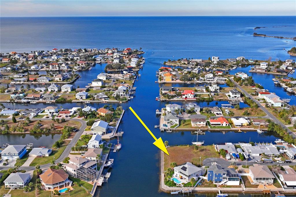 An aerial view of a waterfront residential lot with a house and canal access — Lot 8 6TH ISLE, HERNANDO BEACH, FL