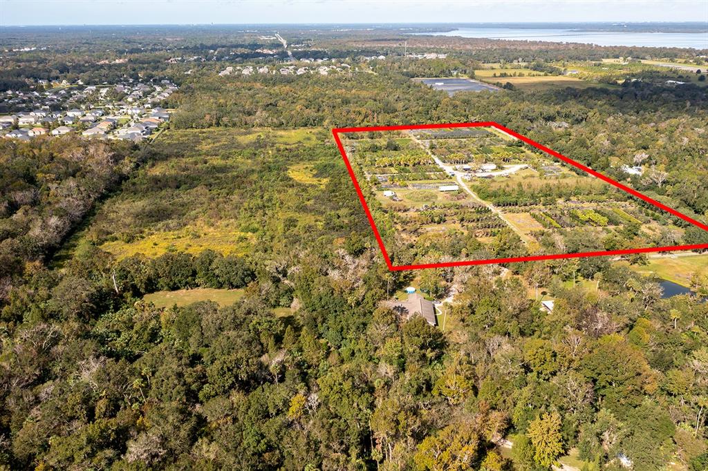 An aerial view shows a large rectangular plot of land marked by a red outline — 850 FLORIDA AVENUE, OVIEDO, FL