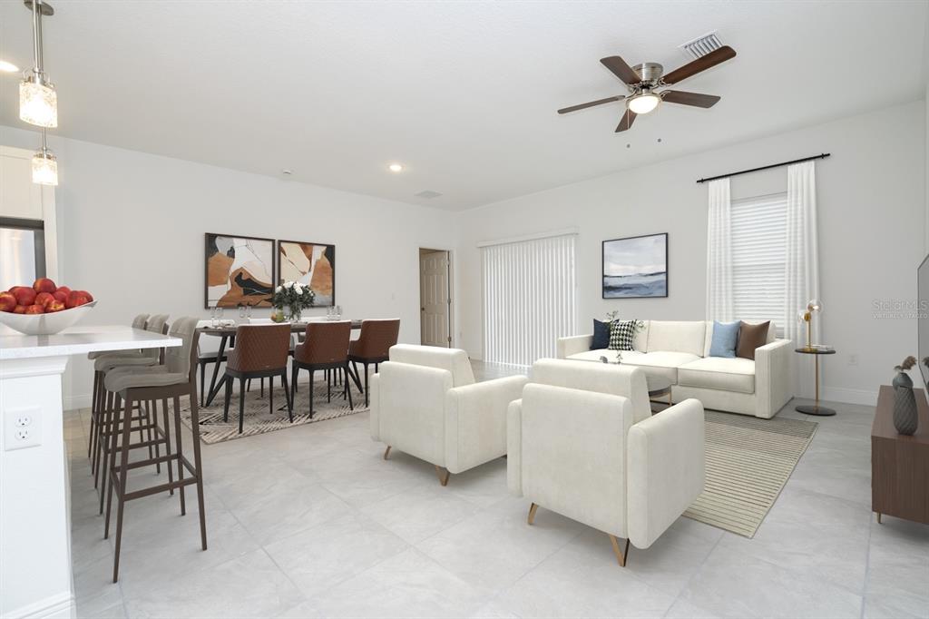 An open-concept living and dining area features white tile floors, neutral furniture, and a fan — 13334 SW 29TH CIRCLE, OCALA, FL