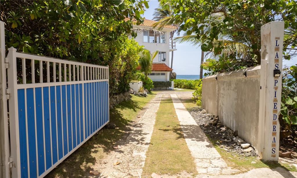 A gated driveway leads toward a multi-story house situated along the oceanfront — 294 BRAVOS DE BOSTON, VIEQUES, PR