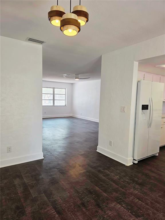 A view from a dining area looking into a living room with dark wood flooring — 5210 DR MARTIN LUTHER KING JR ST N STREET, ST PETERSBURG, FL