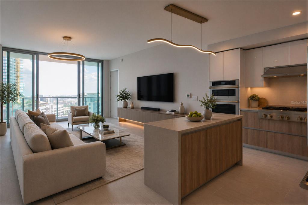 An open-concept living room and kitchen featuring a beige sofa, island, and floor-to-ceiling windows — 400 CENTRAL AVENUE UNIT 1003, ST PETERSBURG, FL