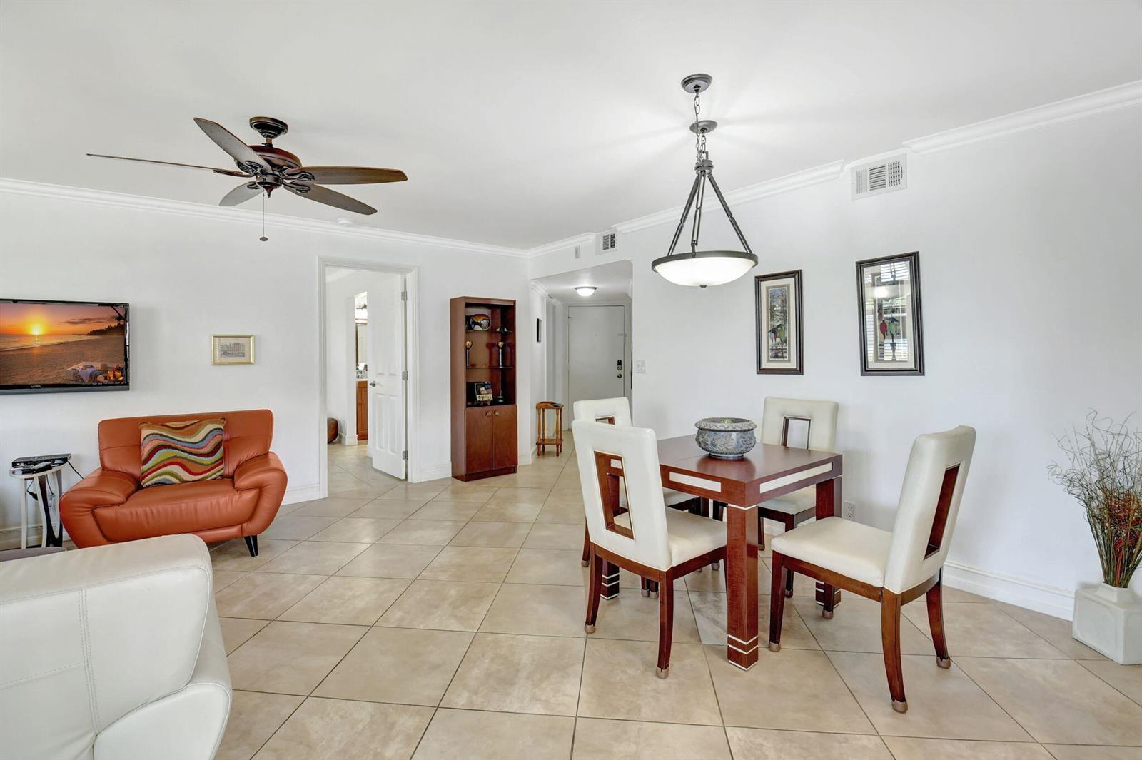 A dining area and living space with tile floors, a ceiling fan, and modern furniture — 600 Egret Circle # 7105, Delray Beach FL 33444, DELRAY BEACH, FL