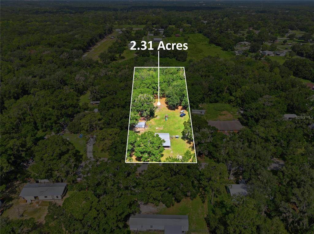 An aerial view shows a rectangular plot of land highlighted as 2.31 acres — 1708 ROBIN STREET, AUBURNDALE, FL