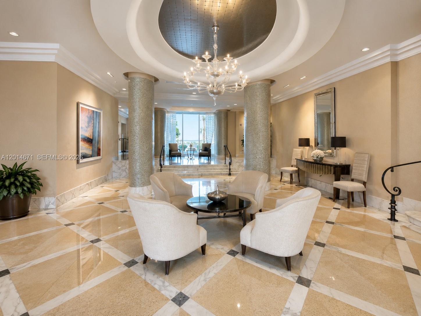A luxurious lobby features a central seating area, marble floors, and a grand chandelier — 6917 Collins Ave # 614, Miami Beach FL 33141, MIAMI BEACH, FL