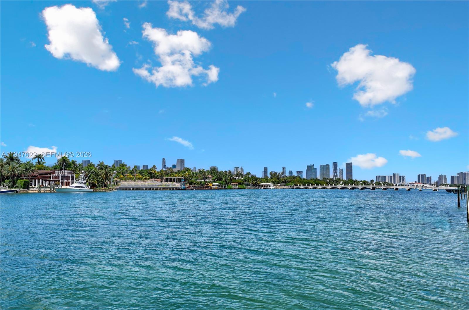 A view of a calm bay with a distant city skyline and a bridge — 56 S Hibiscus Dr, Miami Beach FL 33139, MIAMI BEACH, FL