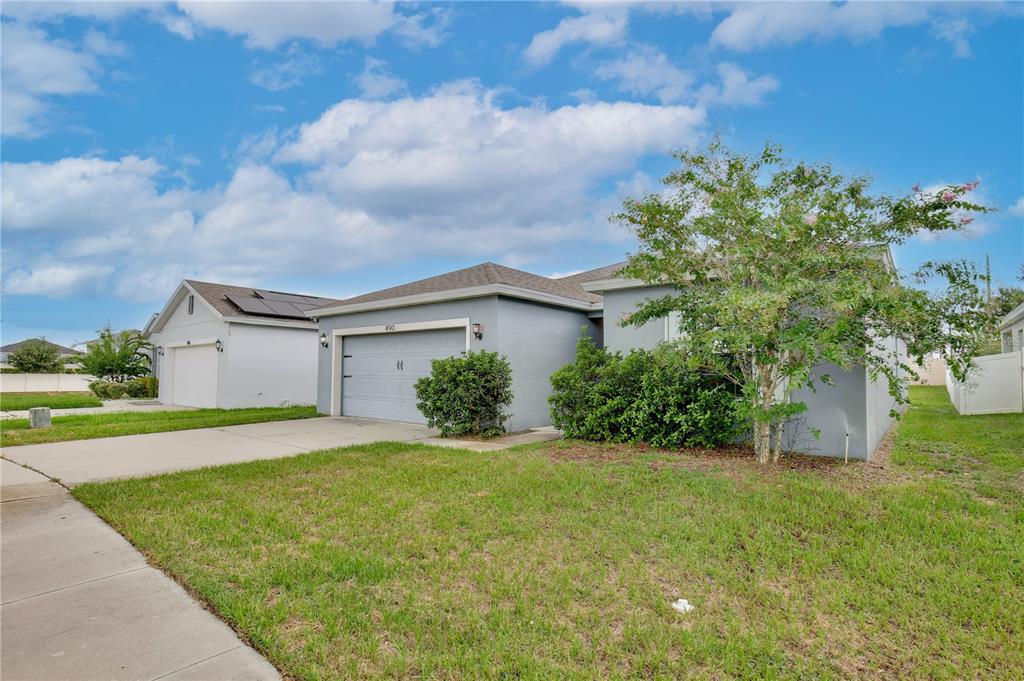 A single-story house with a gray exterior, a two-car garage, and a front lawn — 490 TAFT DRIVE, DAVENPORT, FL