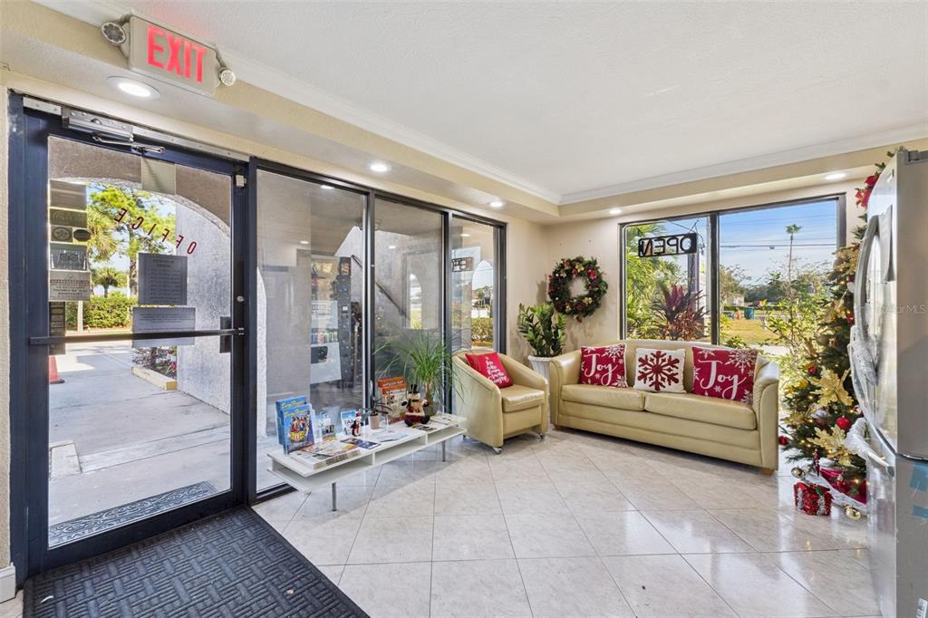 A waiting area features a beige sofa, an armchair, a coffee table, and holiday decorations — 4640 W IRLO BRONSON MEMORIAL HIGHWAY, KISSIMMEE, FL