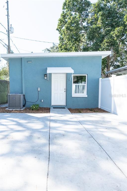 A blue exterior building features a white door, a single window, and an air conditioning unit — 3520 1/2 8TH AVENUE N, ST PETERSBURG, FL