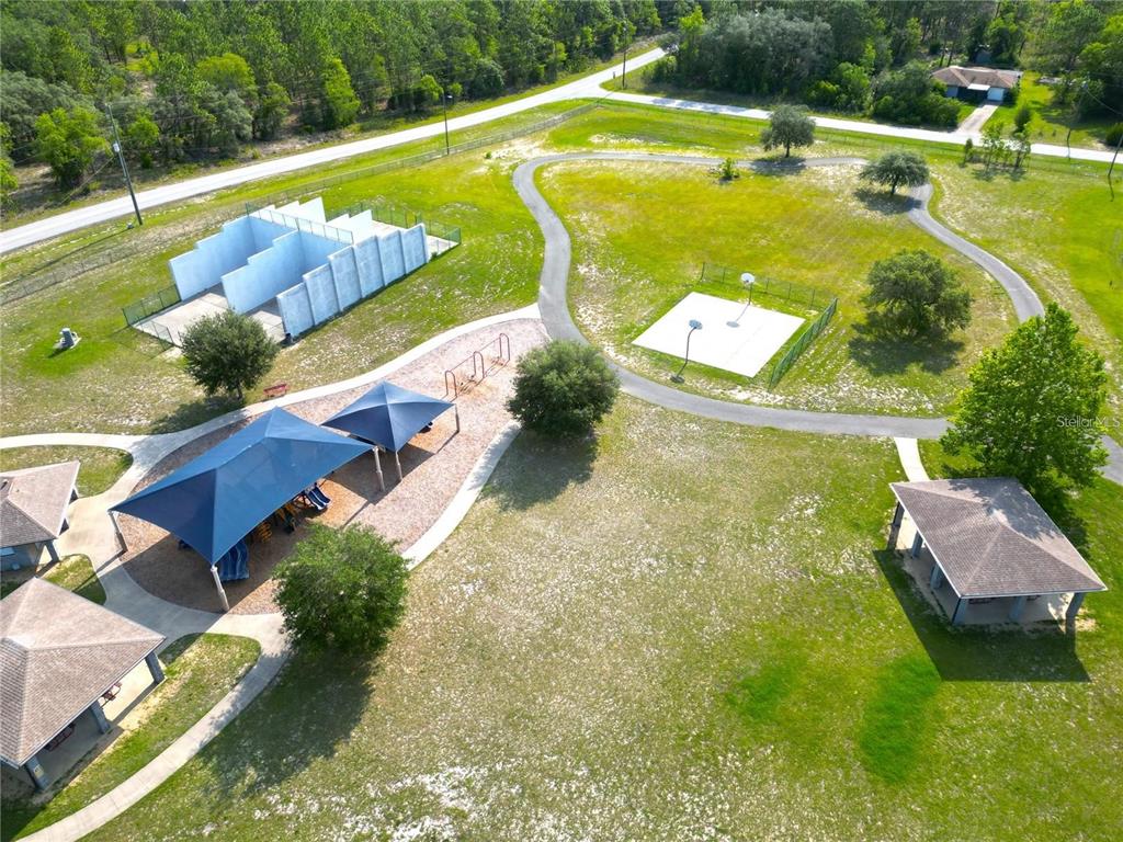 An aerial view of a park featuring a playground, basketball court, and several covered pavilions — Lot 22 SW RAINBOW LAKES BOULEVARD, DUNNELLON, FL