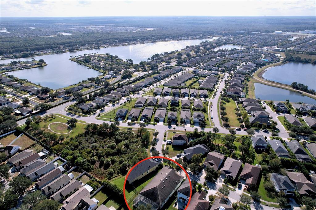 An aerial view shows a residential neighborhood with a highlighted house in the foreground — 6507 NESTALL COURT, APOLLO BEACH, FL