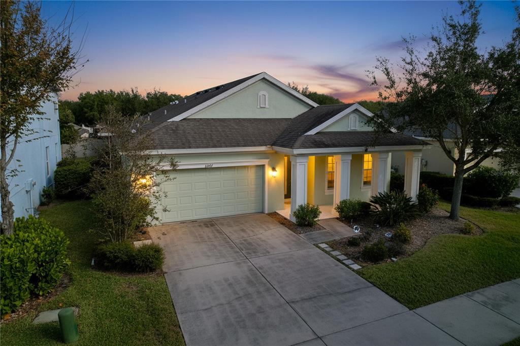 A light green single-story house with a two-car garage and a covered front porch — 6507 NESTALL COURT, APOLLO BEACH, FL