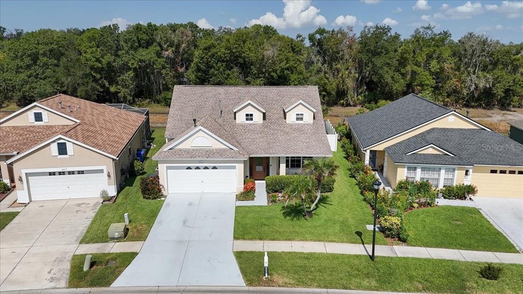 An aerial view shows a suburban house with a two-car garage and two dormer windows — 6615 SUMMER COVE DRIVE, RIVERVIEW, FL