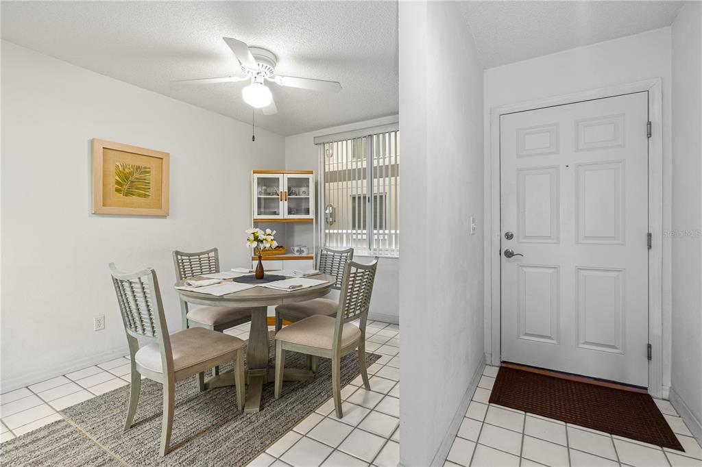 A balcony with a white railing, patio furniture, and a view of trees and buildings — 3 OCEANS WEST BOULEVARD UNIT 3A7, DAYTONA BEACH SHORES, FL