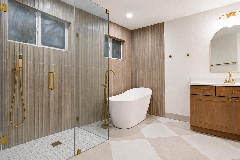 A modern bathroom features a glass-enclosed shower, a freestanding tub, and a wood vanity — 132 GILLIAN DRIVE, SPRING HILL, FL