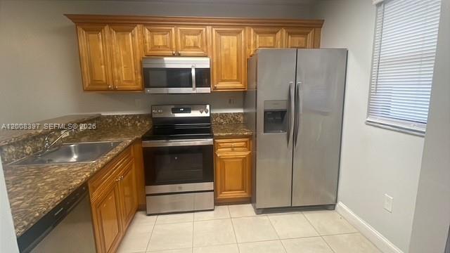 A kitchen features wood cabinets, stainless steel appliances, and granite countertops — 9943 Nob Hill Pl # 9943, Sunrise FL 33351, SUNRISE, FL