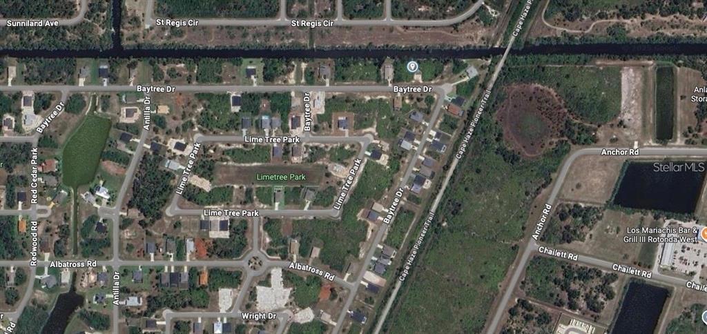 This is an aerial map view of a residential neighborhood with streets and green spaces — 320 BAYTREE DRIVE, ROTONDA WEST, FL