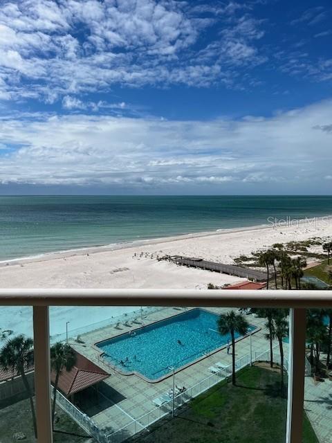 An elevated view shows a swimming pool, a sandy beach, and the ocean — 880 MANDALAY AVENUE UNIT S713, CLEARWATER BEACH, FL