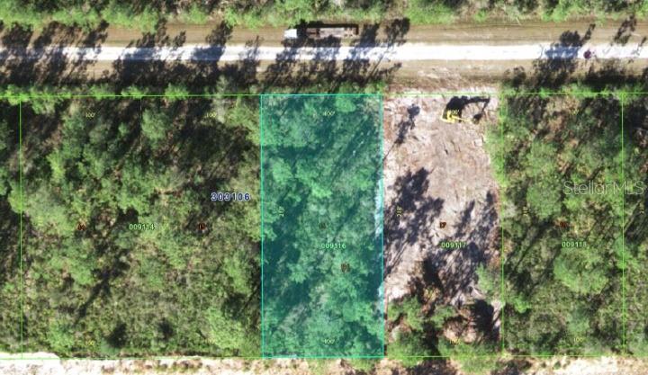An aerial view shows a rectangular, wooded land parcel highlighted in blue among adjacent lots — 417 AZALEA DRIVE, INDIAN LAKE ESTATES, FL