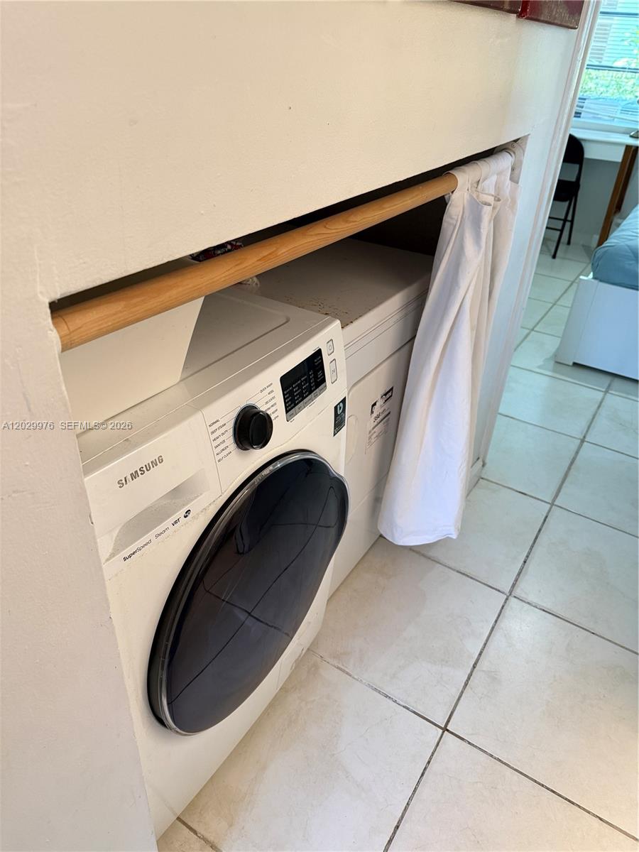 A Samsung front-load washer and dryer are tucked into a recessed laundry alcove — 601 Michigan Ave # 3, Miami Beach FL 33139, MIAMI BEACH, FL
