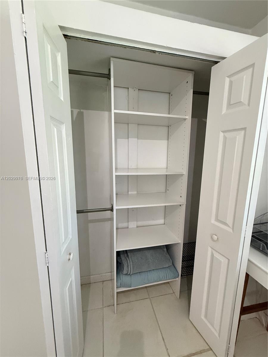 A closet features white shelving units and a hanging rod behind double doors — 601 Michigan Ave # 3, Miami Beach FL 33139, MIAMI BEACH, FL