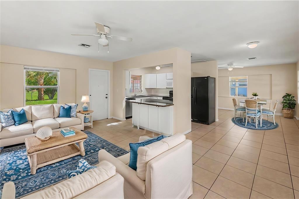 An open-concept living room and kitchen with tile floors and a dining area — 21450 OLEAN BOULEVARD, PORT CHARLOTTE, FL