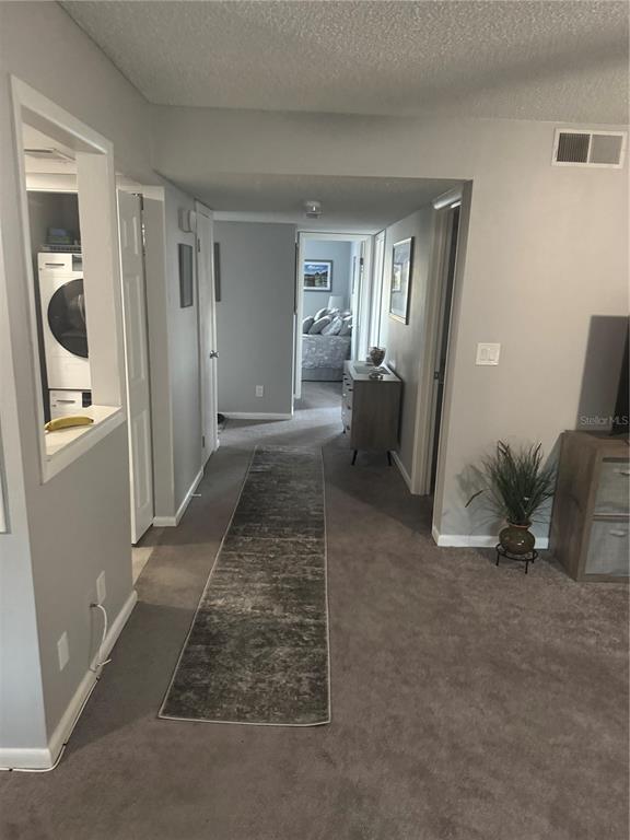 A carpeted hallway leads from a living area toward a bedroom with a laundry closet — 737 MIDWAY DRIVE UNIT B, OCALA, FL