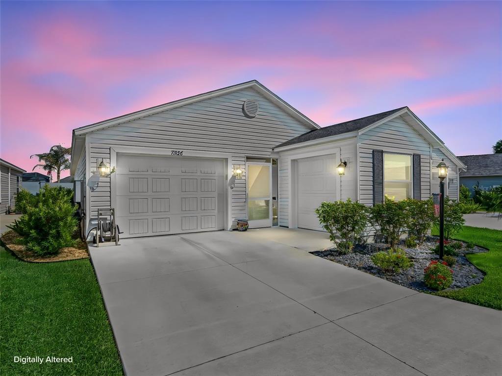 A single-story house with white siding, a two-car garage, and a concrete driveway — 7536 KUENHER COURT, THE VILLAGES, FL