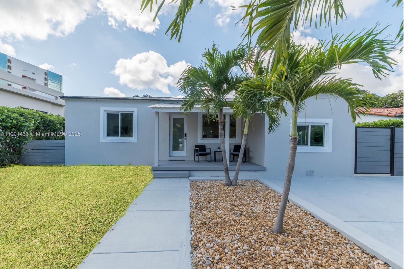 A single-story gray house features a front porch, palm trees, and a gravel garden — 260 NE 46th St, Miami FL 33137, MIAMI, FL