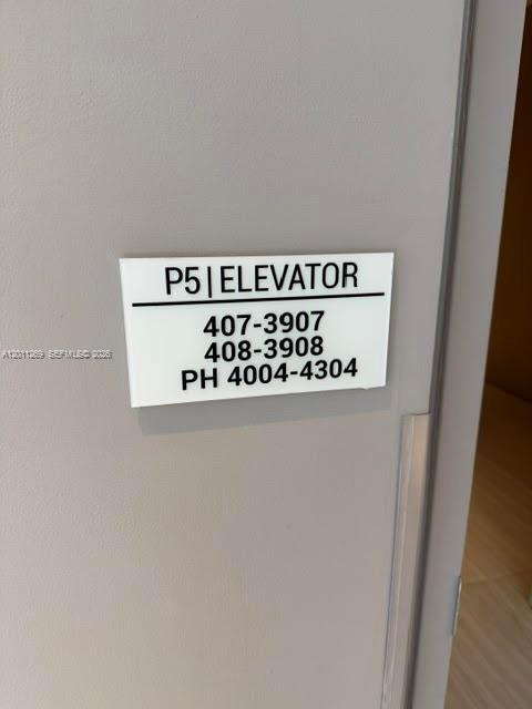 A white sign on a gray wall indicates elevator access for units 407 through 4304 — 460 NE 28th St # 3408, Miami FL 33137, MIAMI, FL