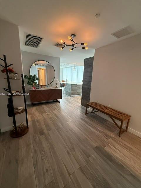 An entryway features a wooden bench, a coat rack, and a console table with a mirror — 460 NE 28th St # 3408, Miami FL 33137, MIAMI, FL
