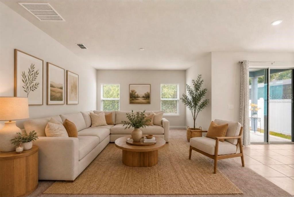A living room features a large sectional sofa, a round coffee table, and an armchair — 357 SIESTA VISTA COURT, DAVENPORT, FL