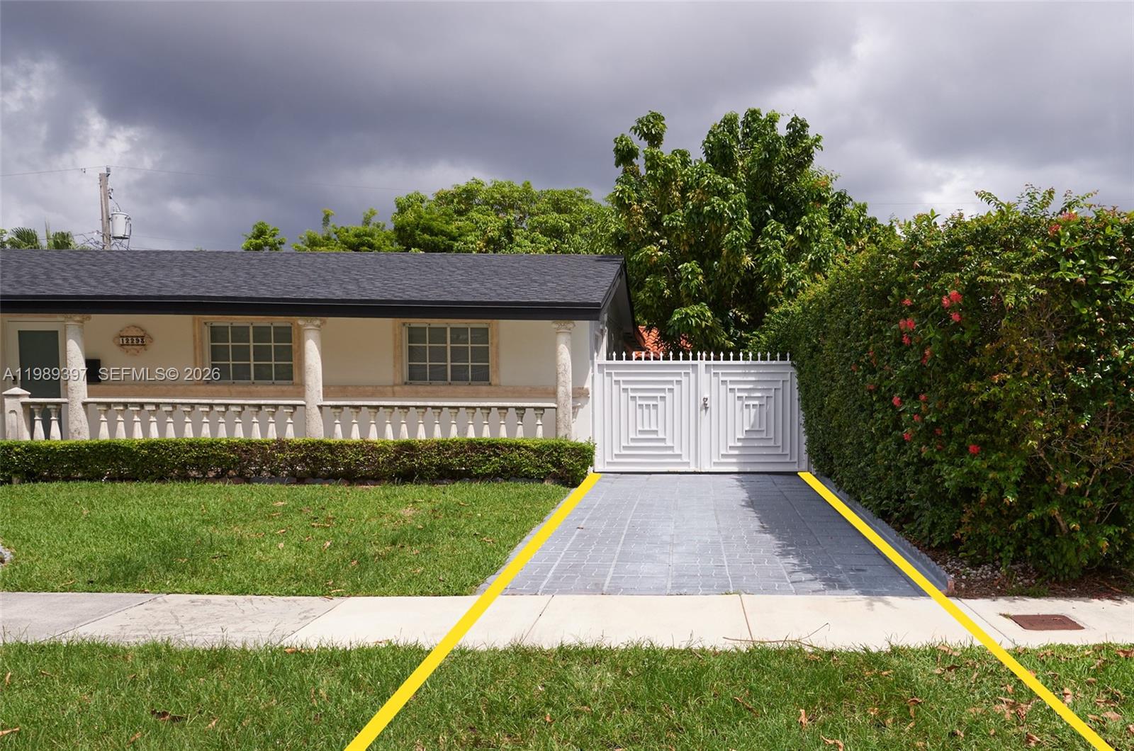 A single-story house with a white gate, a paved driveway, and a manicured hedge — 12293 SW 28th Ter, Miami FL 33175, MIAMI, FL