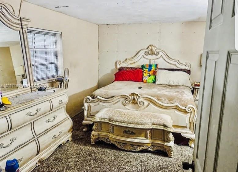A bedroom features a large ornate bed, a matching dresser with a mirror, and carpeted flooring — 14411 NW 15th Dr, Miami FL 33167, MIAMI, FL