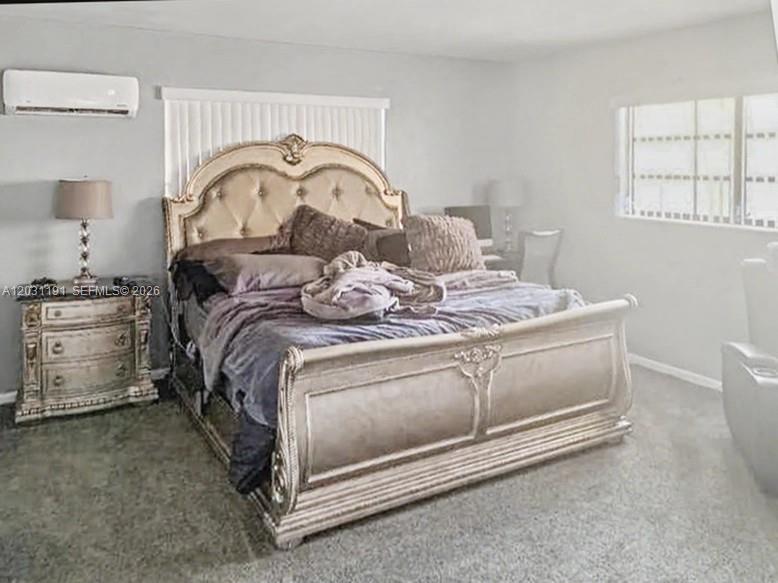 A bedroom features a large ornate bed, a nightstand with a lamp, and a wall-mounted air conditioner — 14411 NW 15th Dr, Miami FL 33167, MIAMI, FL
