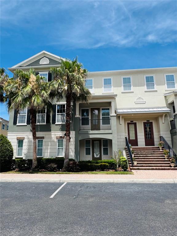 A three-story building with palm trees, a balcony, and a brick staircase entrance — 2583 JOSLIN PLACE, ORLANDO, FL