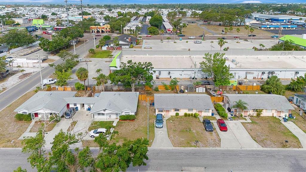 An aerial view shows two single-story duplexes with driveways and cars in a suburban neighborhood — 6520/6522 12TH STREET W, BRADENTON, FL