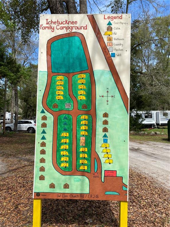This is a hand-painted map of the Ichetucknee Family Campground showing site locations and amenities — 8587 SW ELIM CHURCH ROAD, FORT WHITE, FL