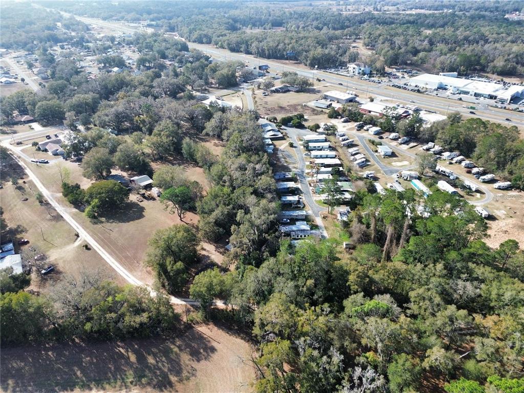 An aerial view shows a rural property with a mobile home park and wooded areas — TBD SE 71ST TERRACE ROAD, BELLEVIEW, FL