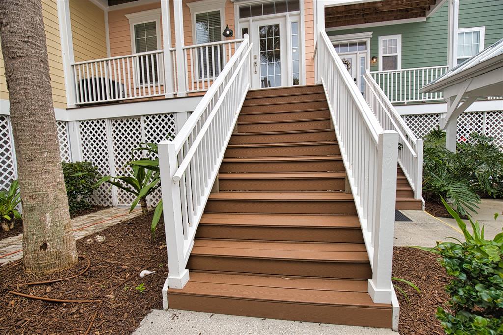 A set of wooden stairs with white railings leads up to the entrance of a house — 11723 ANGLERS CLUB DRIVE UNIT 131, PLACIDA, FL