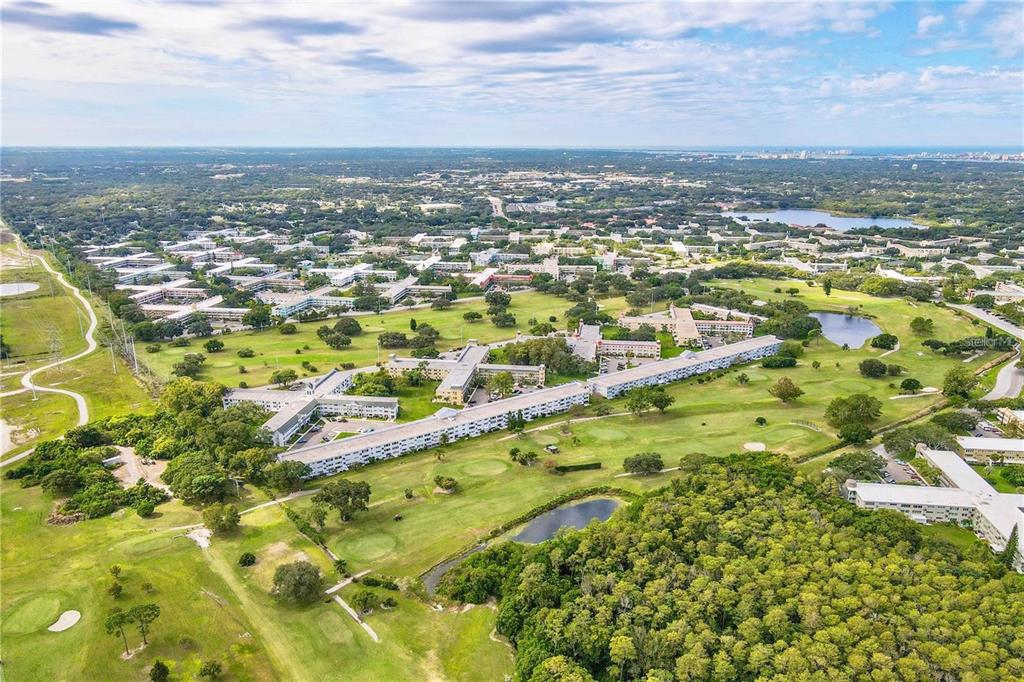 An aerial view of a large apartment complex situated on a sprawling golf course — 2428 COLUMBIA DRIVE UNIT 68, CLEARWATER, FL