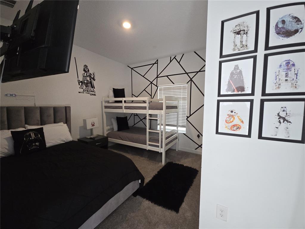 A Star Wars-themed bedroom features a bunk bed, a queen bed, and geometric wall art — 1036 LEADER STREET, DAVENPORT, FL